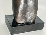 sculpture of a man ' s head on a black base on a white background