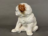 a figurine of a dog with a heart on it ' s head