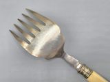 a fork with a wooden handle on a table