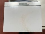 a white dishwasher that is sitting on top of a counter