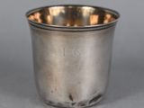 a close up of a silver cup sitting on a table