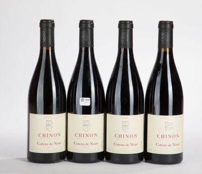 three bottles of red wine are lined up on a white surface