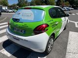 a green and white car parked on the side of the road