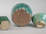 three pieces of pottery sitting next to each other on a white surface