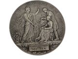 an image of a silver medal with a woman and a man