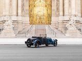 a vintage car that is parked in front of a building