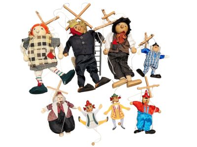 a bunch of puppets that are hanging on a string