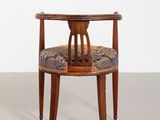 an image of a wooden chair with a blue and brown upholstered seat