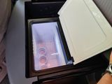 a small refrigerator that is open on the seat of a plane