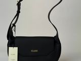 a close up of a black purse on a white surface