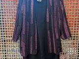 a black dress with a purple and black jacket on a hanger