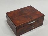 an image of a small wooden box on a white surface