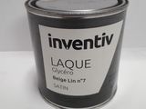 un pot de peinture posé sur une table blanche