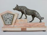 a statue of a dog that is standing on top of a clock