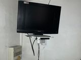 a flat screen tv mounted on the wall in a small room