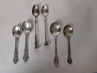 several spoons and spoon spoons are lined up on a white surface
