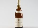 a bottle of wine sitting on top of a white table
