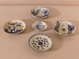 six blue and white bowls with designs on them sitting on a table