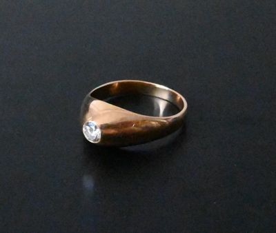 a close up of a ring with a diamond on it