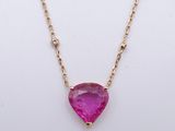 a pink tourmaline and diamond necklace on a gold chain