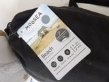 a black bag with a label on it sitting on the floor