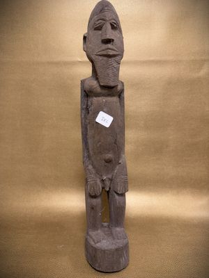 statue of a man holding a sign on a brown background