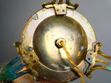 a close up of a metal object with a clock on it