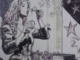 a drawing of a woman blowing bubbles at a table