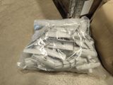 a bag of wii remotes on the floor next to a couch