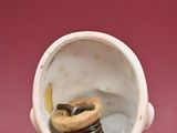 a figurine of a woman with a broken tooth in her mouth