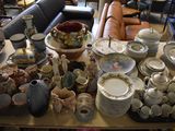 a lot of pottery on the table in the room