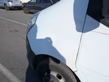 a white van that is parked on the side of the road