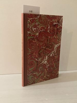 un livre à la couverture rouge posé sur une table blanche