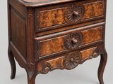 an old wooden chest of drawers with carvings on the drawers