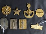 some of the badges are gold and silver on a black background