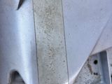 a close up of a piece of metal with a pair of scissors on it