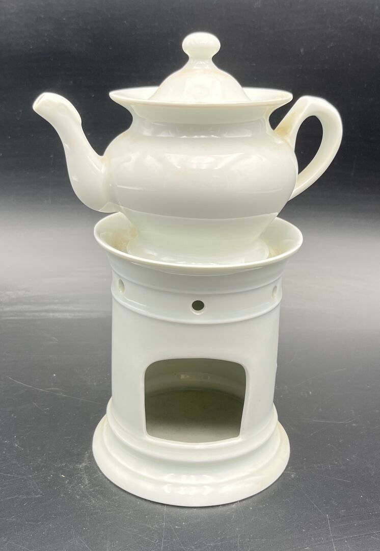 Une tisanière égoïste et sa chaufferette en porcelaine blanche. H 23,5 cm.