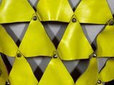 a mannequin made of yellow and silver triangles