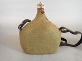 tan flask bottle with black strap on a white background