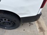 a white car with a black rim parked on the side of the road