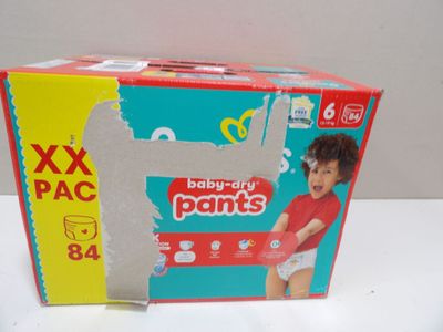 a box of diapers on a table with a baby in it