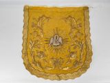 an image of a yellow cloth with a bird and flowers on it