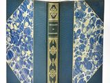 a blue book with gold trim and a blue cover