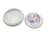 a small white box with a picture of a little girl on it