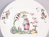 a white plate with a picture of a woman and flowers on it