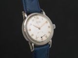 a close up of a wrist watch with a blue strap