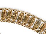 bracelet with gold and diamonds on a chain on a white surface