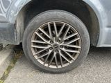 a close up of a car ' s tire on the street
