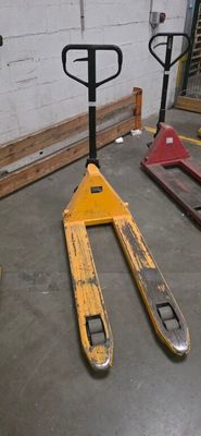 a forklift sitting on the floor in a warehouse