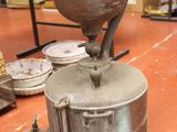 an old coffee grinder sitting on a table in a room